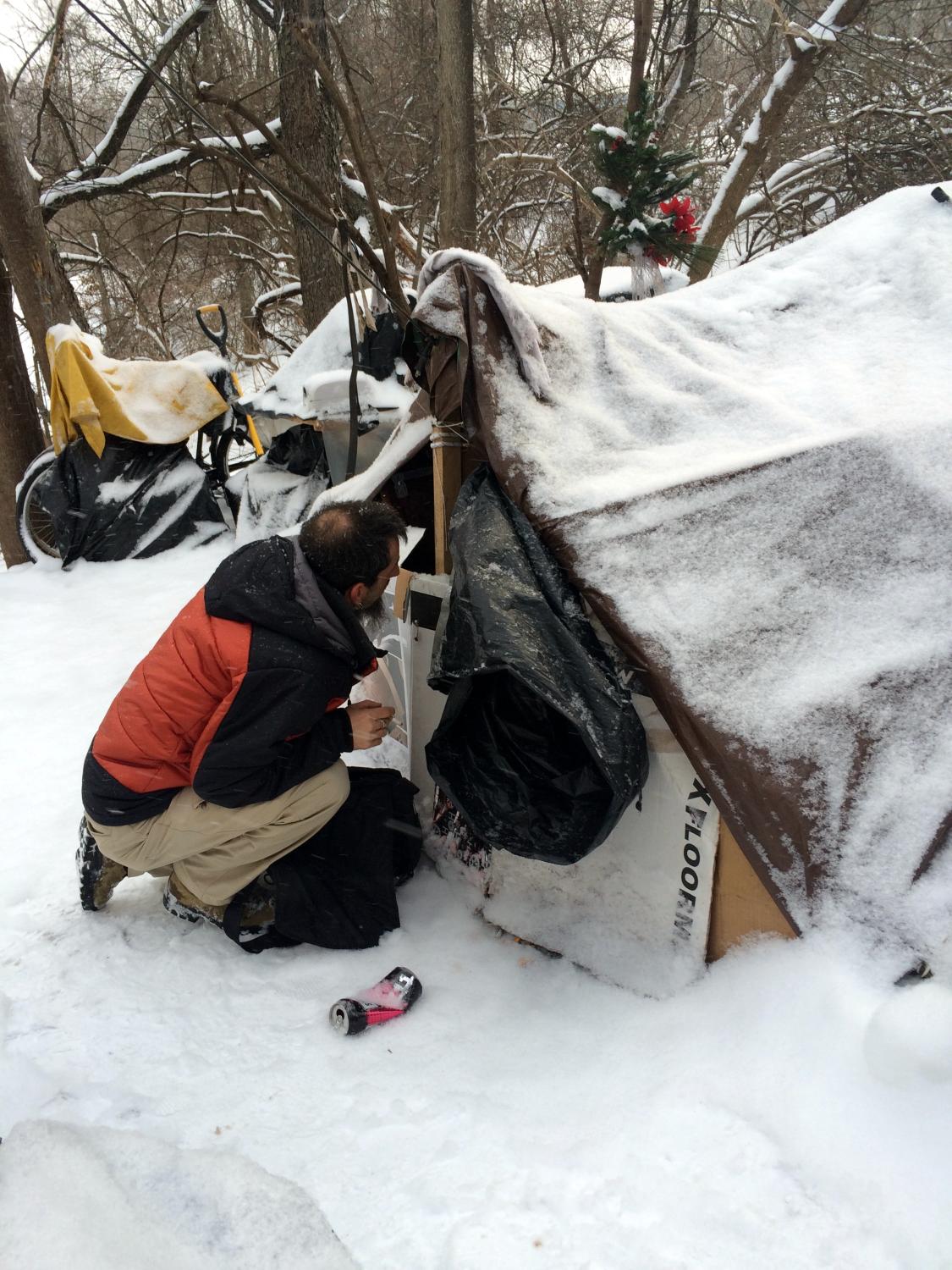 Staff member looking at a homeless camp.