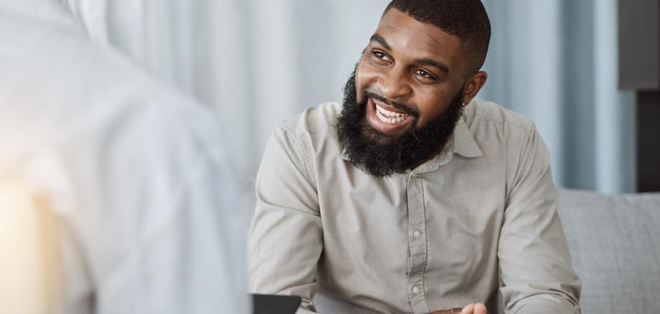Man Sitting Down and Smiling