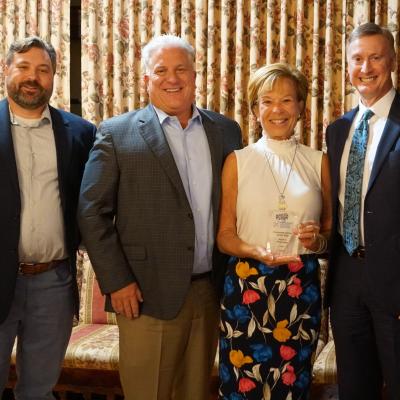 Klein's Pharmacy owners Barry and Ann Klein accept the Corporate Donor of the Year Award from board member Aaron Kurchev, left, and CSS CEO Bob Stokes.