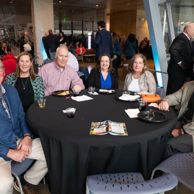 Art of Recovery guests from the Reymann Foundation seated at a round table.