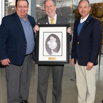 Representatives from SeibertKeck accept their sponsor gift of a framed drawing.