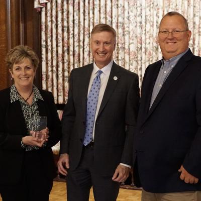 GBS CEO Michele Benson stands with CSS CEO Bob Stokes (center) and GBS CFO JP Schippert