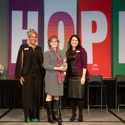 Dr. Schwartz with her award standing between Aimee Wade and Chrissy Myers of the ADM Board