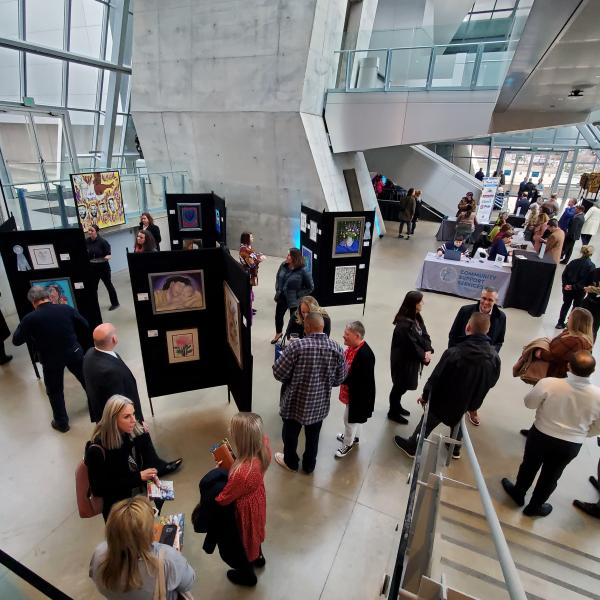 People look at artwork at Art of Recovery