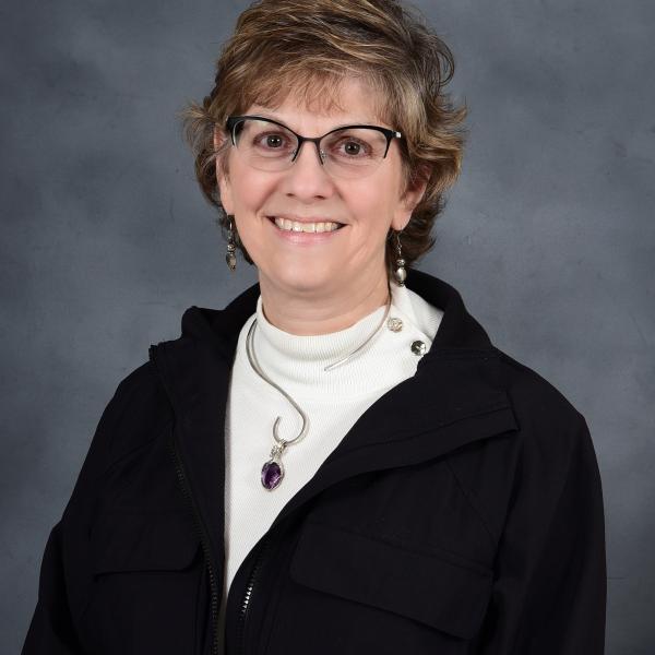 Photo of Dr. Schwartz wearing a white shirt and black jacket