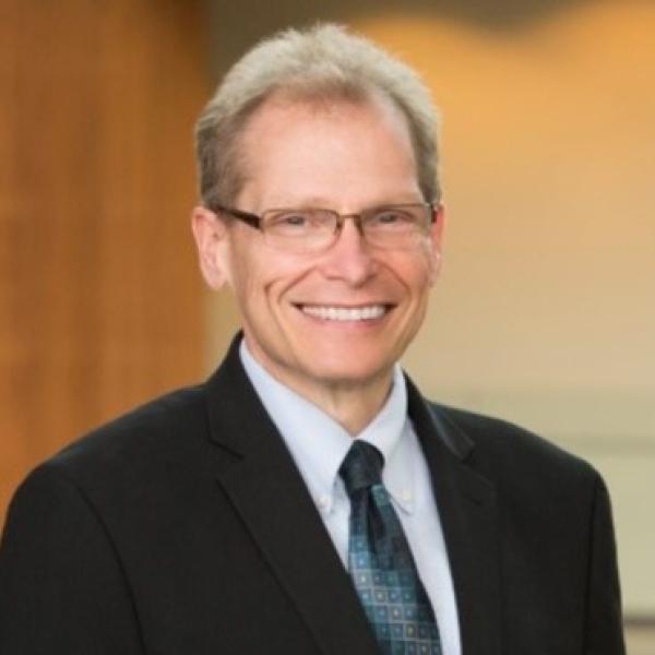 A head-and-shoulders photo of Paul Jackson in a suit and tie.